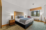 Experience comfort and style in this beautifully appointed hotel room, featuring a plush king-sized bed with elegant bedding and a decorative throw.