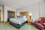 Experience comfort and style in this beautifully appointed bedroom, featuring a plush king-sized bed with a luxurious upholstered headboard.
