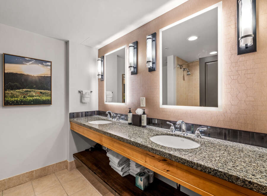 This luxurious bathroom features a spacious double vanity with granite countertops and modern chrome fixtures, perfect for any morning routine.