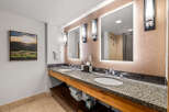 This luxurious bathroom features a spacious double vanity with granite countertops and modern chrome fixtures, perfect for any morning routine.
