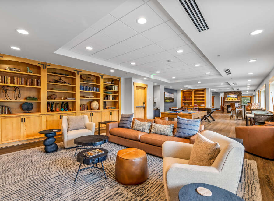 Experience ultimate relaxation in this inviting lounge area, featuring a plush leather sofa and comfortable armchairs perfect for unwinding.