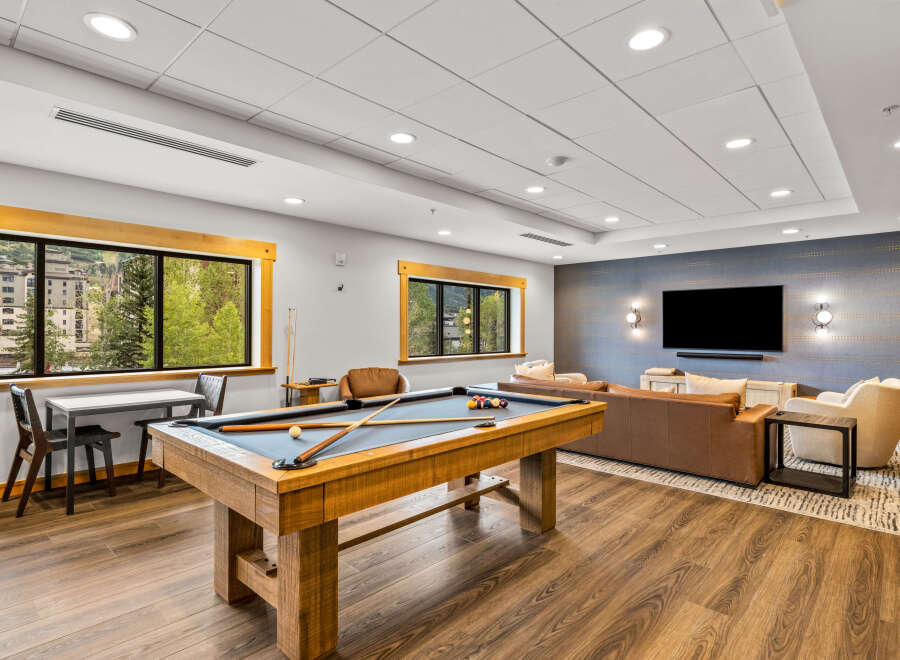 Enjoy leisure and entertainment in this spacious game room, featuring a professional billiard table and a comfortable lounge area.