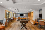 Experience ultimate relaxation and entertainment in this spacious lounge area, featuring a pool table and foosball table for endless fun.