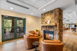 Cozy up by the natural stone fireplace in this inviting living space, perfect for relaxing after a day of outdoor adventures.