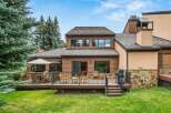 Enjoy outdoor living with this spacious deck featuring a dining set and lounge chairs, perfect for entertaining.