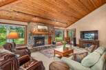 Experience rustic charm in this inviting living room, featuring a magnificent stone fireplace as the centerpiece.