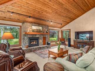 Experience rustic charm in this inviting living room, featuring a magnificent stone fireplace as the centerpiece.