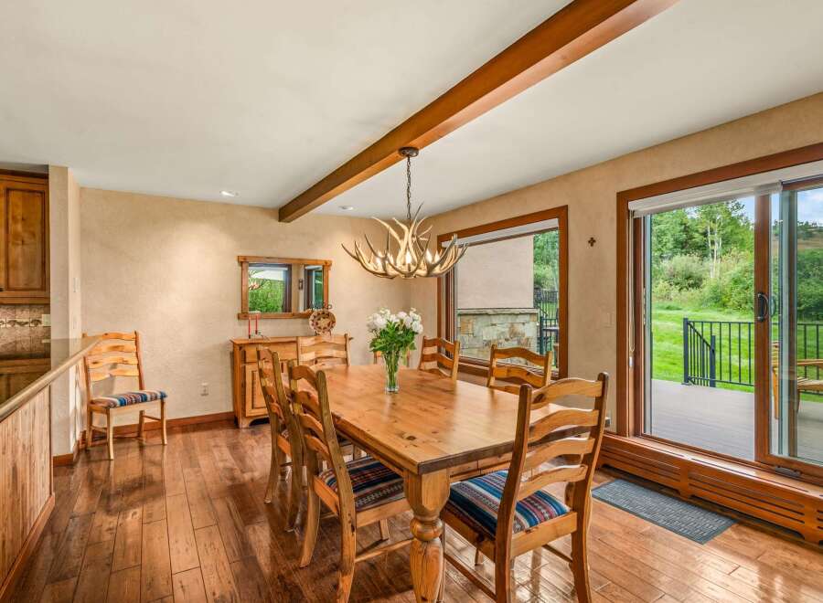 Experience rustic charm in this inviting dining room, featuring a solid wood table perfect for family gatherings.
