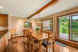 Experience rustic charm in this inviting dining room, featuring a solid wood table perfect for family gatherings.
