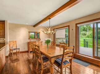 Experience rustic charm in this inviting dining room, featuring a solid wood table perfect for family gatherings.