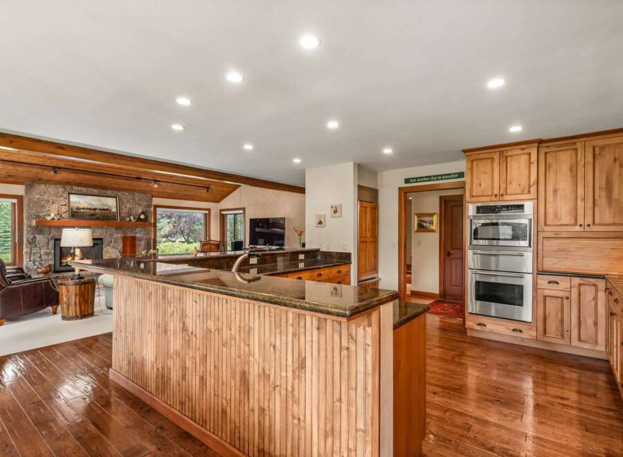Experience rustic charm and modern convenience in this spacious kitchen and living area.