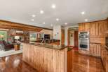 Experience rustic charm and modern convenience in this spacious kitchen and living area.