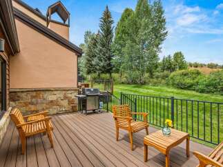 Enjoy outdoor living on this spacious deck, perfect for entertaining or relaxing.