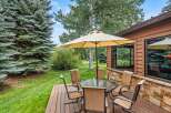 Enjoy outdoor living on this charming deck, complete with a glass-top dining table and comfortable seating, perfect for al fresco meals.