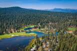 Experience luxury living amidst a stunning natural landscape with this aerial view of a golf course community.