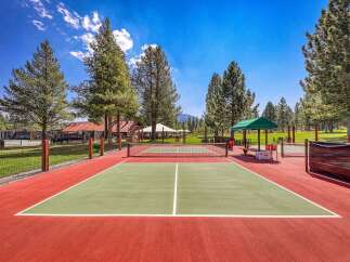Enjoy outdoor recreation on this vibrant pickleball court, perfect for friendly matches and active living.