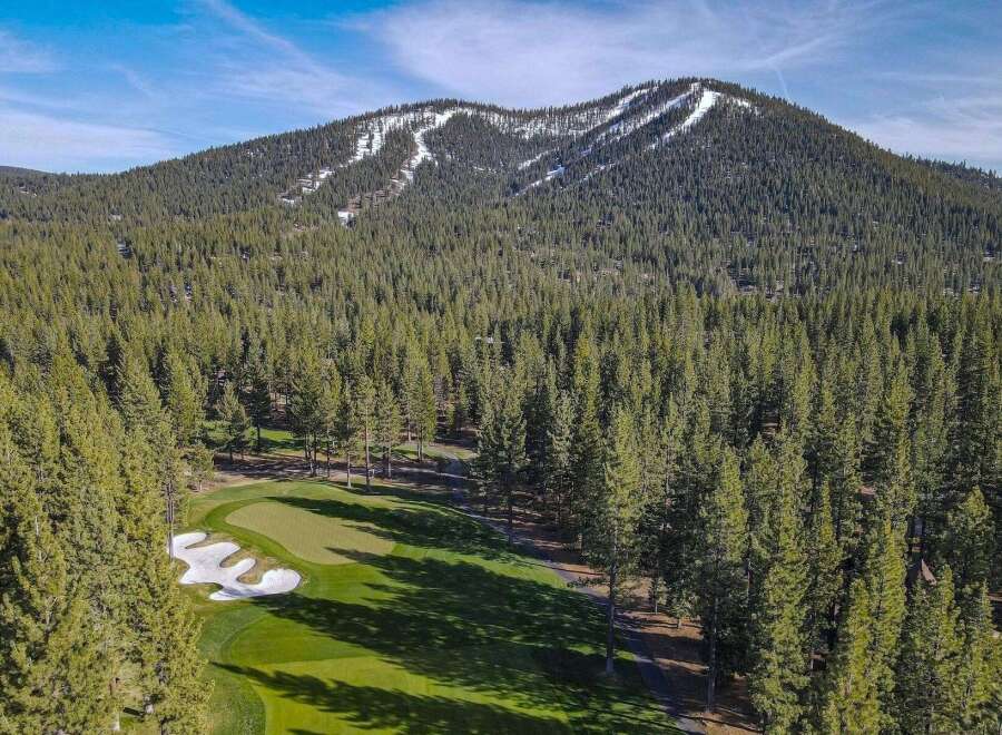 Experience the ultimate mountain lifestyle with this stunning property offering a picturesque golf course setting nestled amongst a dense forest of evergreen trees.