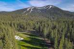 Experience the ultimate mountain lifestyle with this stunning property offering a picturesque golf course setting nestled amongst a dense forest of evergreen trees.