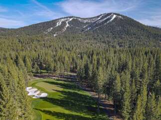 Experience the ultimate mountain lifestyle with this stunning property offering a picturesque golf course setting nestled amongst a dense forest of evergreen trees.