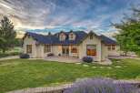 This stunning home features a spacious backyard with a paved patio, perfect for outdoor entertaining.