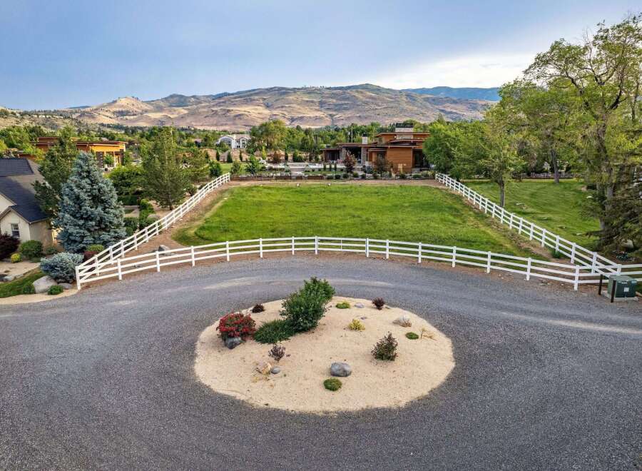 Discover this stunning property featuring a modern home with expansive green spaces, perfect for outdoor living and entertaining.