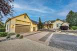 Discover this stunning home featuring a spacious driveway with decorative brick inlays, leading to a large garage.