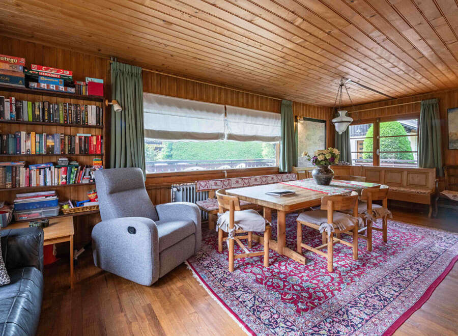 This cozy dining area features a rustic wooden table surrounded by four chairs, perfect for intimate meals.