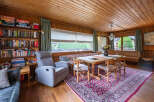 This cozy dining area features a rustic wooden table surrounded by four chairs, perfect for intimate meals.