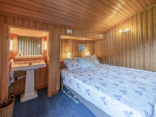 This charming bedroom features a cozy bed with a floral-patterned duvet, perfect for a restful night's sleep.