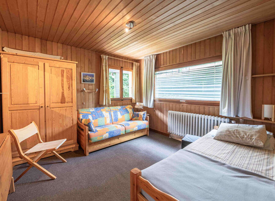 This charming room features a cozy wooden interior, perfect for a relaxing getaway.
