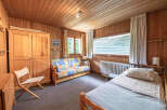 This charming room features a cozy wooden interior, perfect for a relaxing getaway.