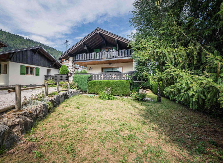 Charming alpine chalet with a spacious balcony offering scenic mountain views.