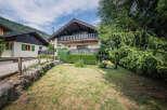 Charming alpine chalet with a spacious balcony offering scenic mountain views.