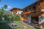 Experience alpine living in this charming wooden chalet, perfect for a mountain getaway.