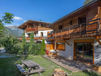 Experience alpine living in this charming wooden chalet, perfect for a mountain getaway.