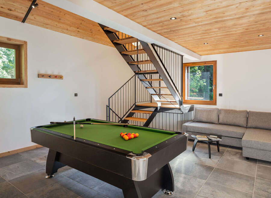 Experience ultimate relaxation and entertainment in this stylish living space, featuring a professional billiard table perfect for friendly games.