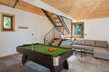 Experience ultimate relaxation and entertainment in this stylish living space, featuring a professional billiard table perfect for friendly games.