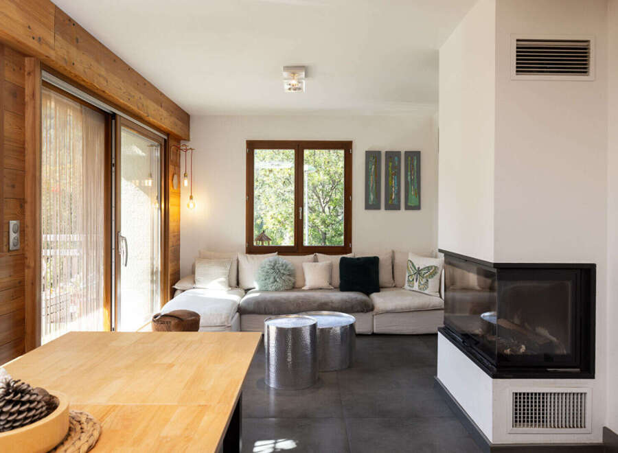 Experience modern mountain living in this stunning living room, featuring a sleek corner fireplace and a large sectional sofa perfect for cozy evenings.