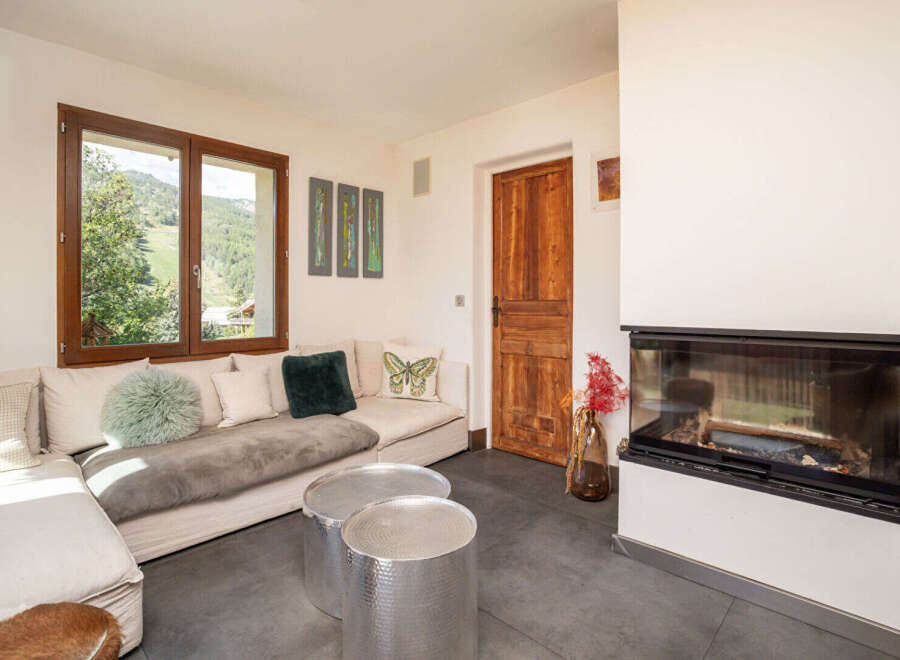 Experience breathtaking mountain views from this cozy living room, featuring a comfortable sectional sofa and a modern fireplace.