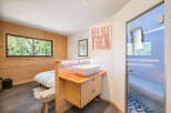 Experience ultimate relaxation in this modern bedroom featuring a unique en-suite bathroom with a vessel sink and a luxurious glass-enclosed shower.
