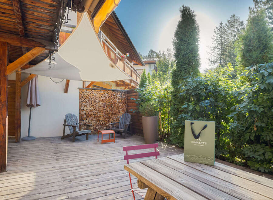 Enjoy the serene outdoor living space of this property, featuring a spacious wooden deck perfect for relaxation and entertaining.
