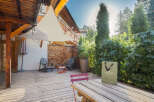 Enjoy the serene outdoor living space of this property, featuring a spacious wooden deck perfect for relaxation and entertaining.