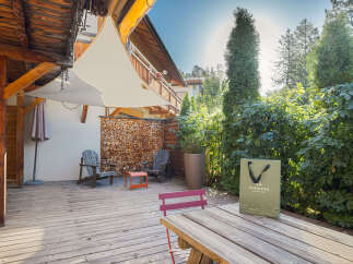 Enjoy the serene outdoor living space of this property, featuring a spacious wooden deck perfect for relaxation and entertaining.
