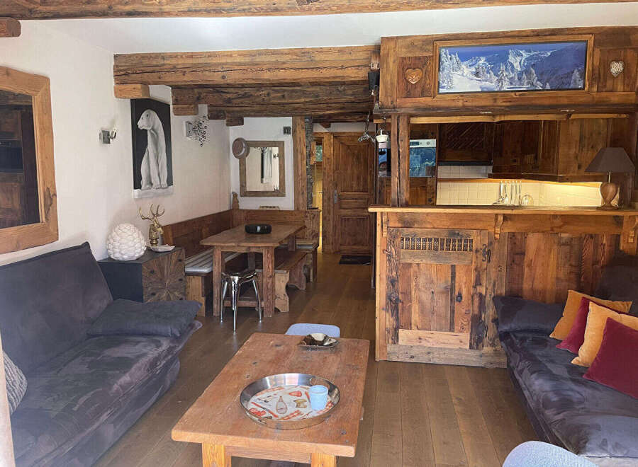 Experience rustic charm in this cozy mountain retreat, featuring exposed wooden beams and a warm, inviting atmosphere.