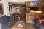 Experience rustic charm in this cozy mountain retreat, featuring exposed wooden beams and a warm, inviting atmosphere.