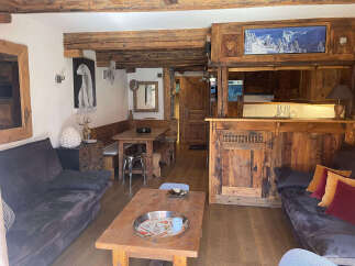 Experience rustic charm in this cozy mountain retreat, featuring exposed wooden beams and a warm, inviting atmosphere.