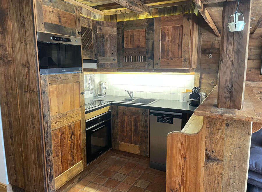 Experience rustic charm in this beautifully appointed kitchen, featuring custom-built wooden cabinetry that exudes warmth and character.