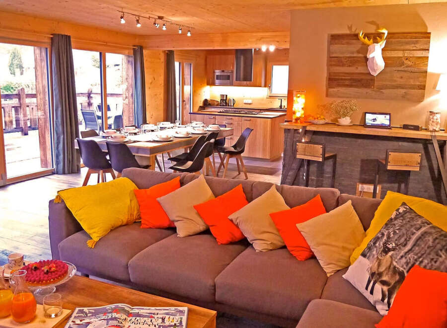 Experience modern alpine living in this stunning chalet, featuring a spacious open-plan living, dining, and kitchen area perfect for entertaining.