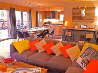 Experience modern alpine living in this stunning chalet, featuring a spacious open-plan living, dining, and kitchen area perfect for entertaining.