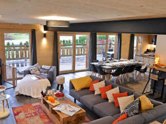Experience modern mountain living in this stunning open-concept chalet, featuring a spacious living and dining area perfect for gatherings.